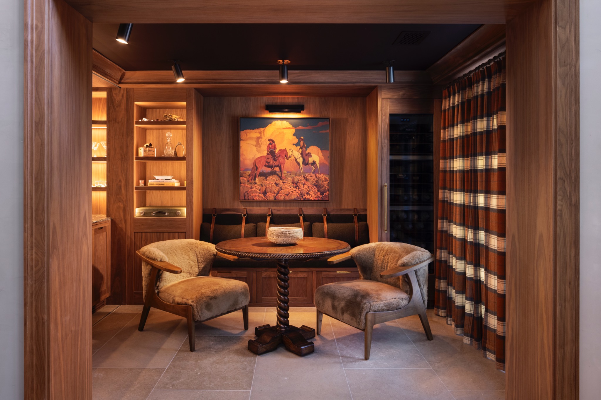 Walnut-lined sitting room with a banquette and round table at Adobe Canyon